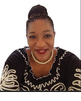 Unity Smiling woman in black patterned dress.